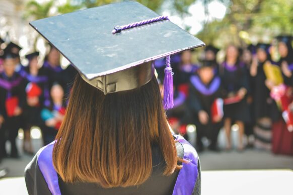 female high school student wearing cap and gown about to graduate virtual high school