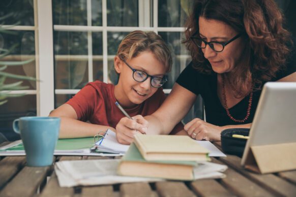 mom helping son with schoolwork at virtual school