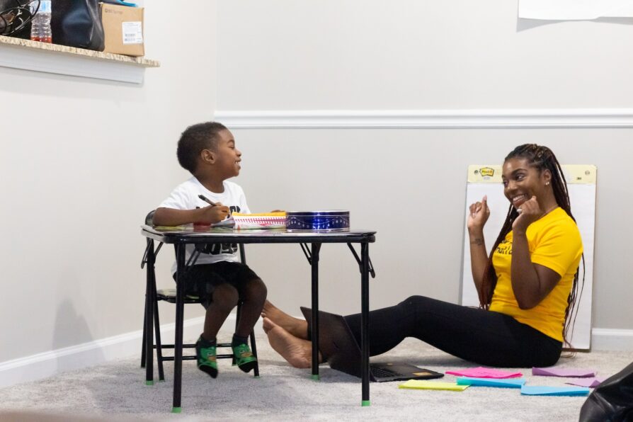 african american instructional coach teaching her child at home