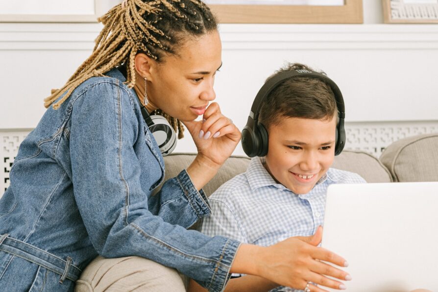 half african american woman as the learning instructor helping her son with schoolwork