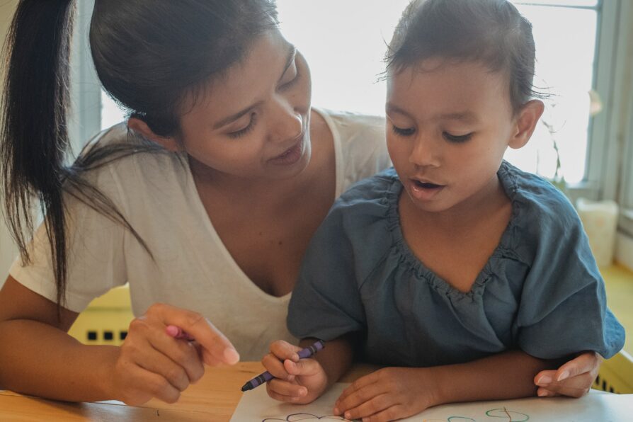 parent acting as a learning coach and helping her child do math