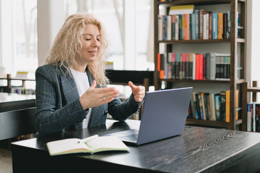 teacher talking virtually to a parent and answering questions
