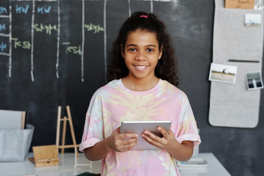 africa american student wearing a tie dye shirt doing schoolwork