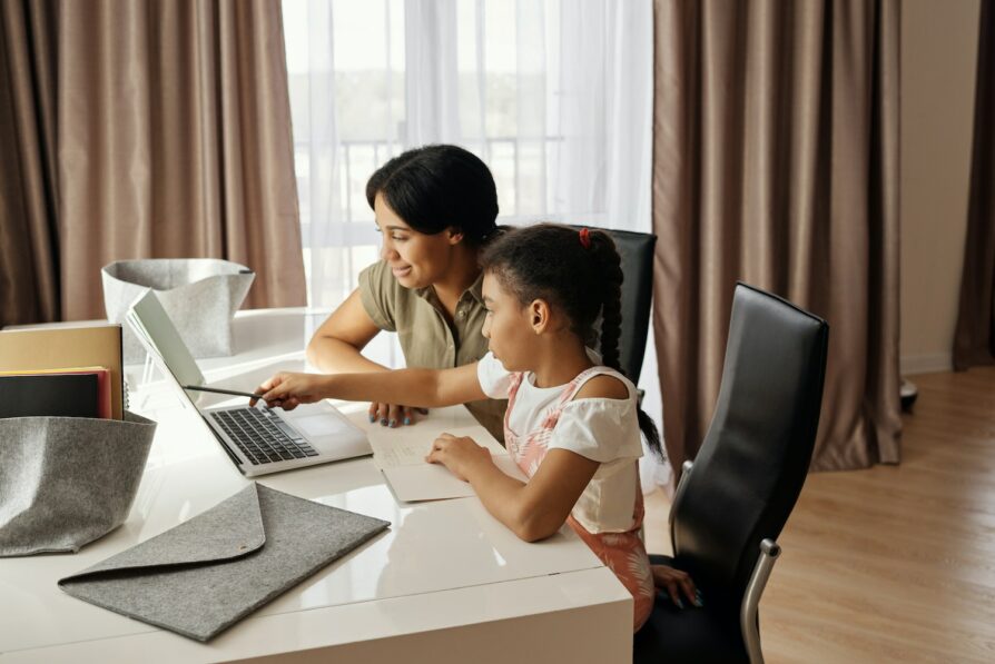 parent or learning coach working with student on homework