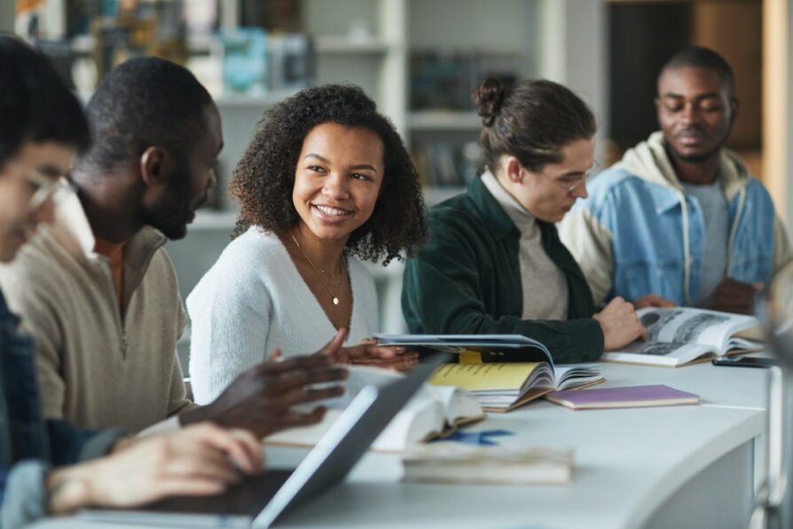 african american high school student looking at her classmate