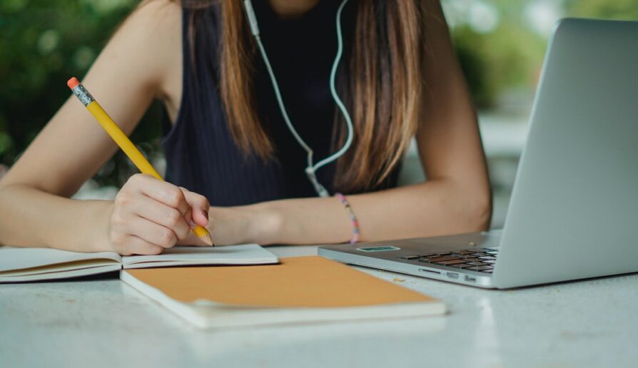 caucasian female student doing homework for virtual school