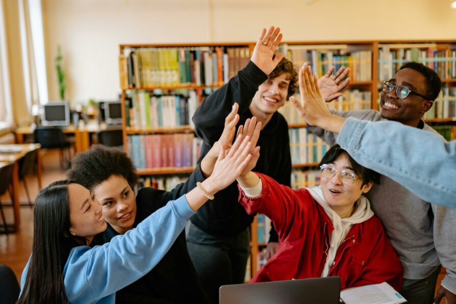 group of high school students cheering for completing a project for school in oregon