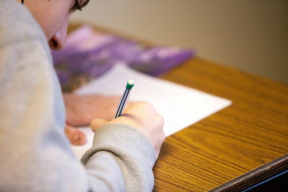 male student writing an essay