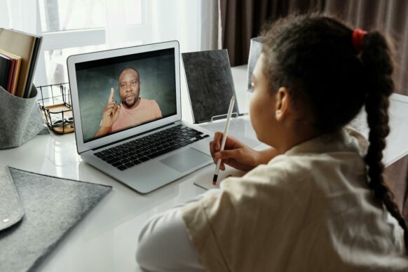 student taking notes for virtual school