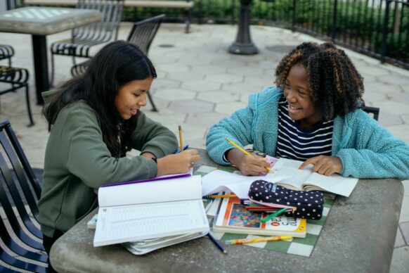two students in middle doing homework together and feeling motivated