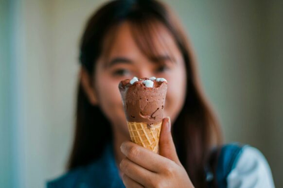 student holding her icecream reward after completing her school assignments