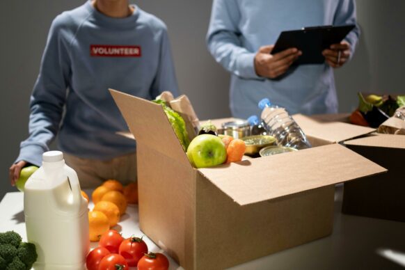 two kids volunteering at a food drive