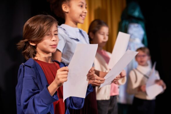 student practicing script for theater