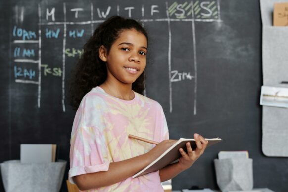 african american female student writing in her notebook