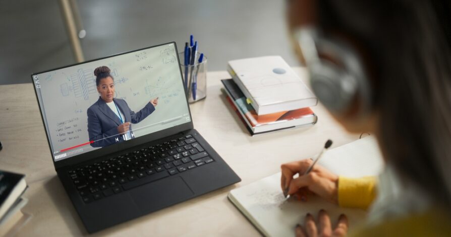 student taking notes during virtual school