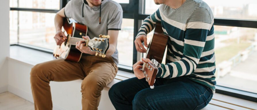 students taking guitar lessons