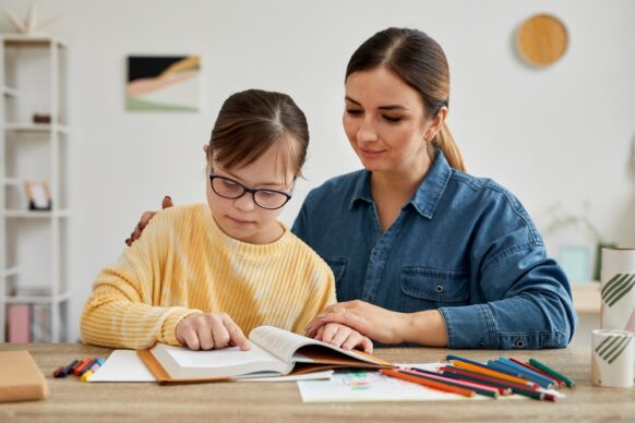 woman teaching her special needs kid for virtual school